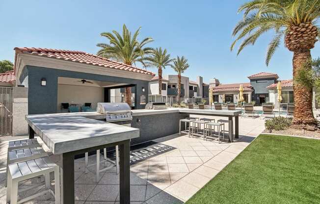 a patio with tables and chairs and palm trees