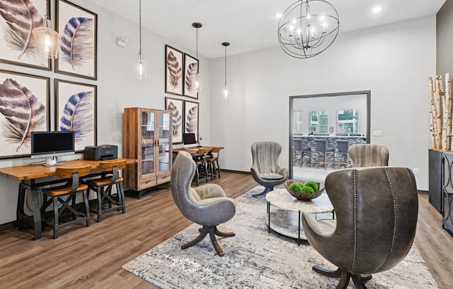 A modern living room with a wooden floor and a large grey chair in the center.