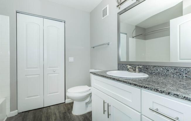 a kitchen with a sink and a mirror