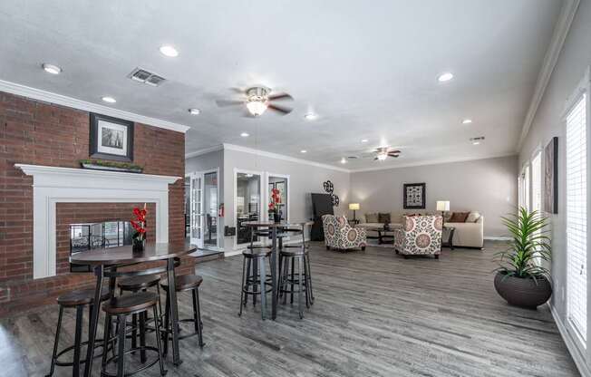 A living room with a fireplace and a bar area.