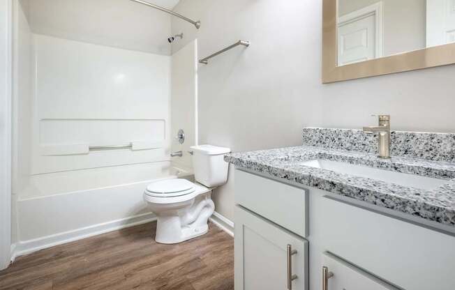 A white toilet sits next to a sink in a bathroom.