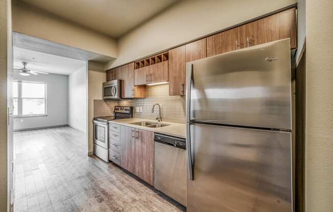 A kitchen with wooden cabinets and stainless steel appliances  at Platform 14, Hillsboro, OR