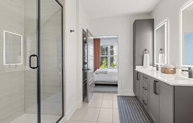 A bathroom with a walk-in shower and a double vanity.