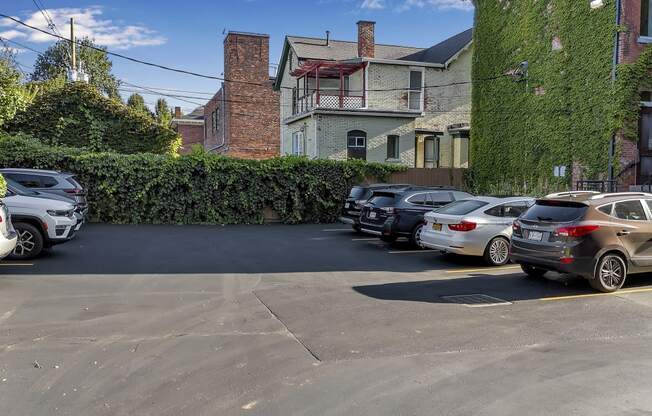 a parking lot filled with cars in front of a building