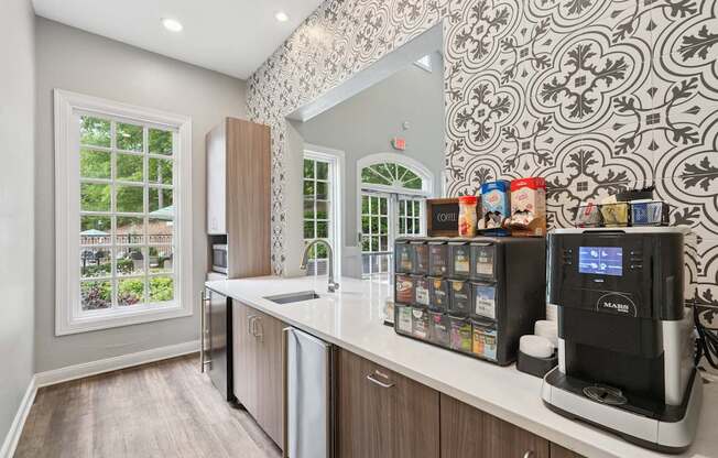 A modern kitchen with a coffee machine and a refrigerator.