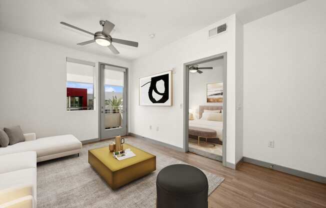 a living room with white walls and a ceiling fan
