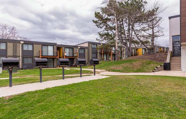 A series of modern townhouses with a grassy front yard.