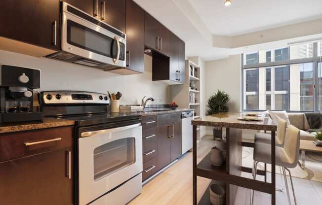 a kitchen with a stove and microwave and a table