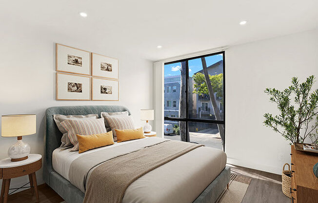 A bedroom with a large bed and a view of the city.