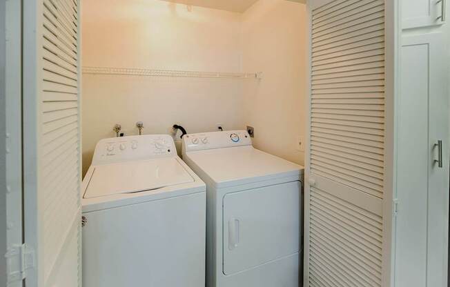 A small laundry room with a washer and dryer.