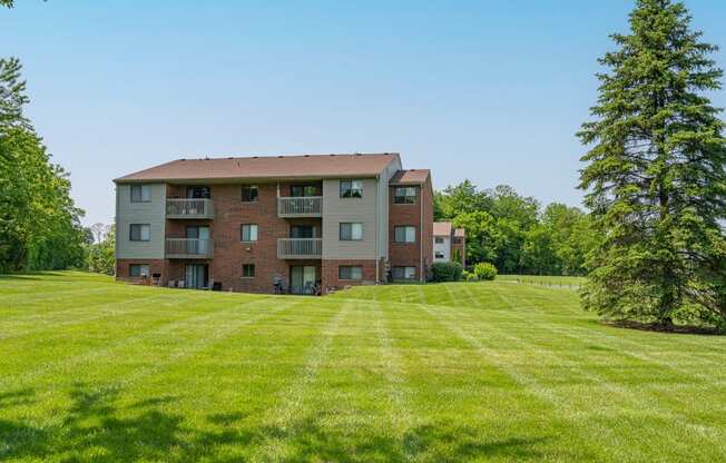 a large apartment building on a green lawn