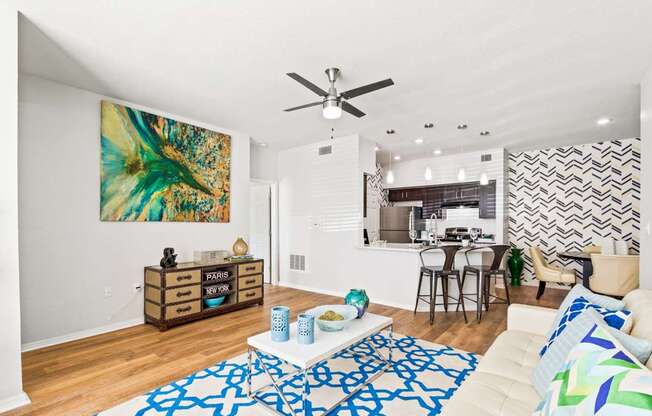 a living room with a couch and a ceiling fan