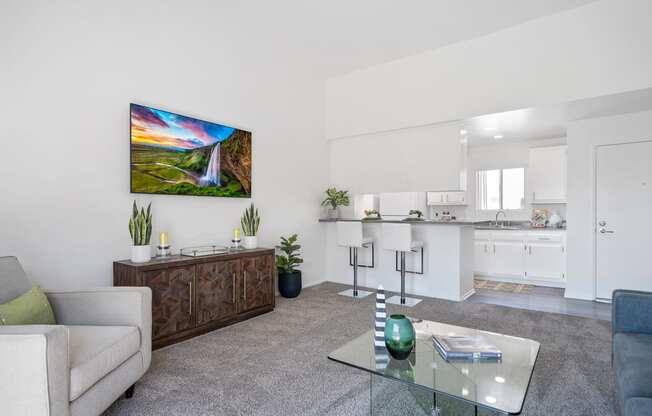 a living room with a couch and a glass coffee table