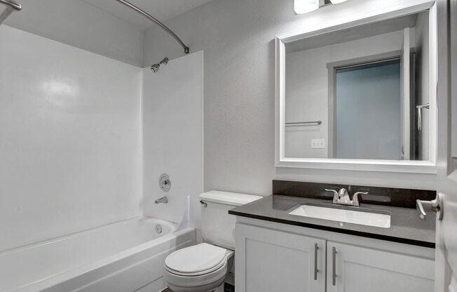 a bathroom with a sink toilet and bathtub