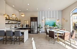 A modern kitchen with a dining table and chairs.