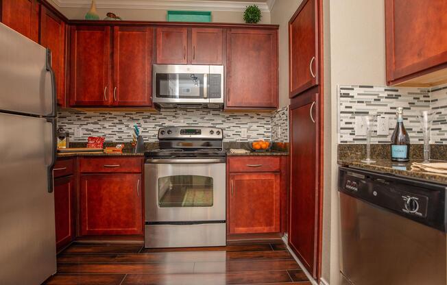 a kitchen with stainless steel appliances and wooden cabinets