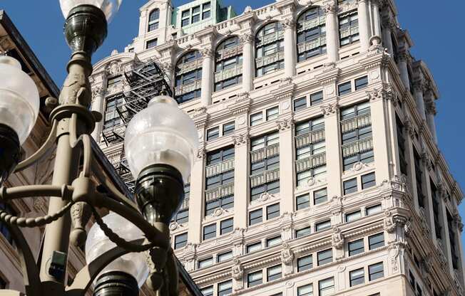 a street light in front of a tall buildingat Book Tower, Detroit, MI