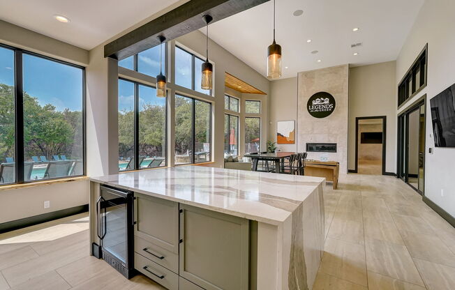 a large kitchen with a large island and large windows