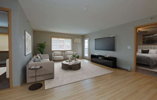 a living room with a rug and a couch and a television. Fargo, ND Urban Plains Apartments