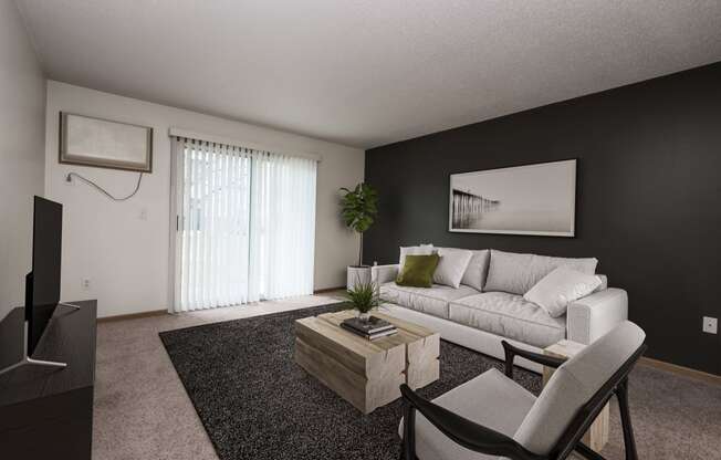 a living room with a white couch and a coffee table. Fargo, ND Stonebridge Apartments