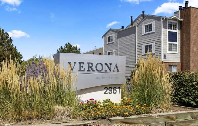 an apartment building with a sign in front of it at Verona, Littleton, 80123
