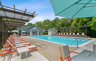 A poolside area with sun loungers and a pool.