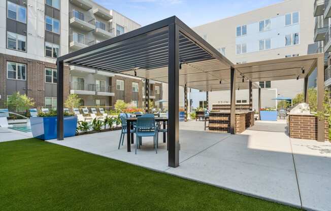 a patio with a table and chairs under awning