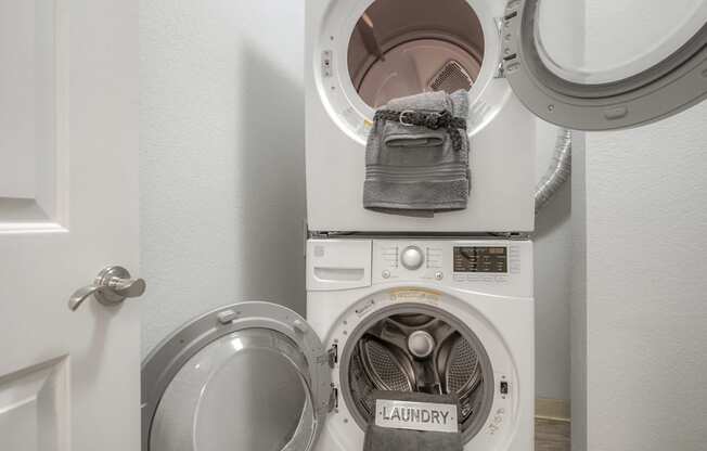 a washing machine and dryer in a small laundry room