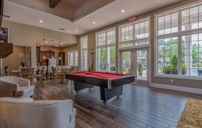 clubhouse with billiards table and large windows
