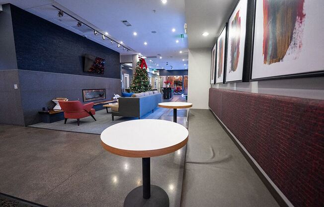 a lobby with tables and chairs and a christmas tree