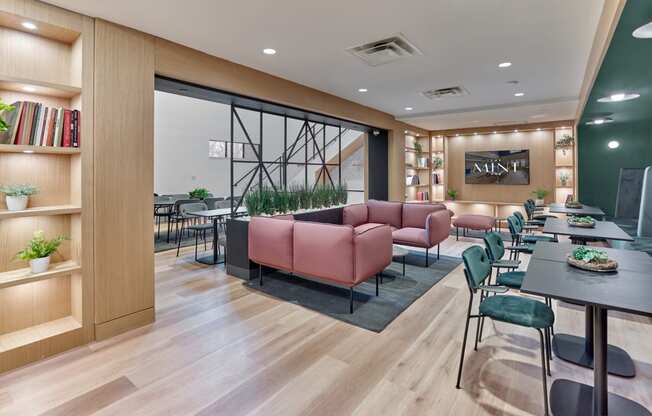 Stylish lounge area at The Mint Rahway with comfortable seating and a large screen, near Rahway Train Station and Newark Airport.