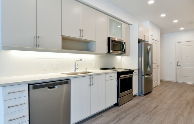 Luxe finishes and features throughout, including Whirlpool appliances and a full-height backsplash.