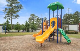 a playground with a swing set and slides