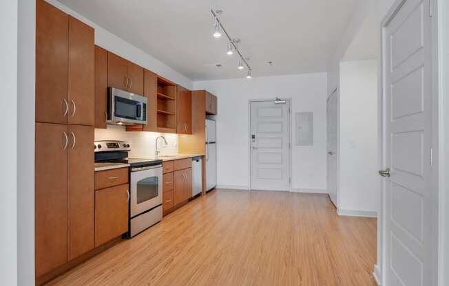 12 South Apartments - Nashville TN - kitchen with dark wood cabinets and stainless steel appliances