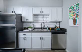 Dog-Friendly Apartments in Arlington TX - Stadium 700 Apartments Kitchen With Modern Finishes, Stainless Steel Appliances, And Sleek White Cabinetry