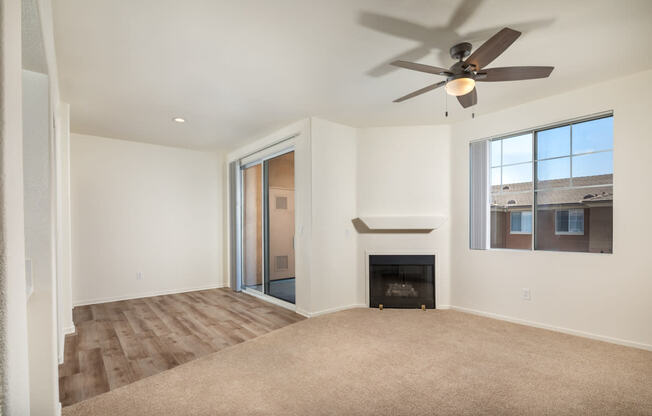 a living room with a fireplace and a ceiling fan