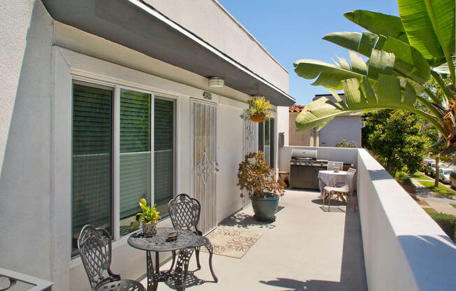 Apartment balcony with BBQ/grill and outdoor furniture