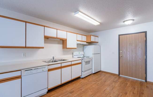 a kitchen with white appliances. Fargo, ND Eagle Run Apartments