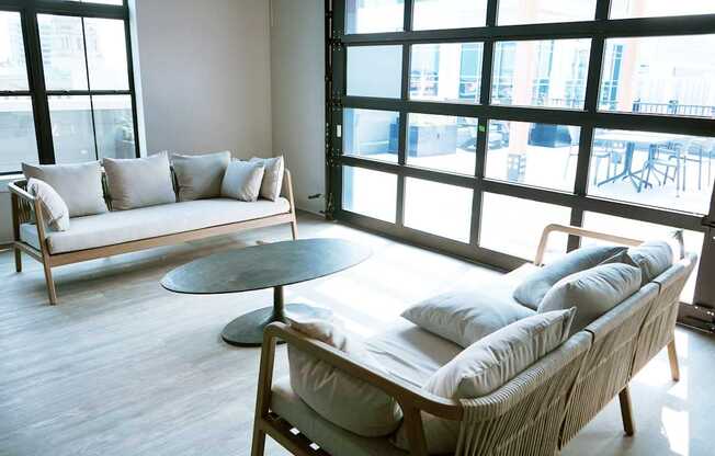 Community room with a couch, chair, and table at The Pearl, Fort Wayne
