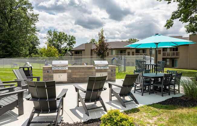 our apartments have an outdoor patio with a grill and table