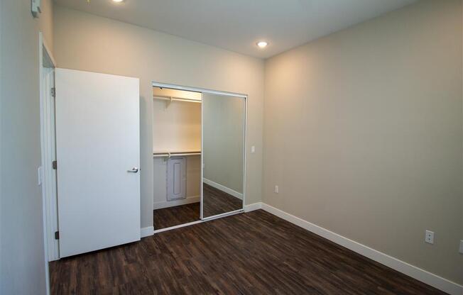a bedroom with a closet and a door to a bathroom at Loma Villas Apartments, San Bernardino