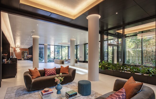 Uncover a world of comfort and style at Mabel. This stunning lobby features contemporary design, lush greenery, and inviting spaces, perfect for relaxation and connection. Elevate your lifestyle today! Schedule a tour now.