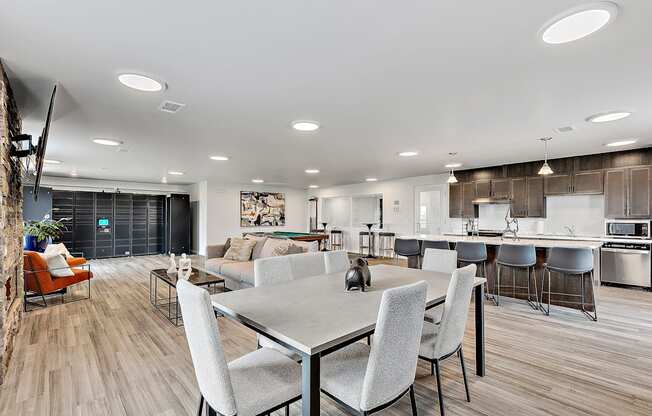 a living room and kitchen area with a dining table and chairs