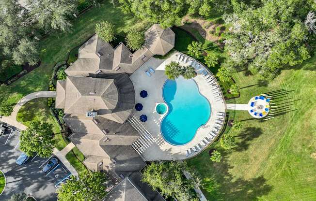 a backyard pool with a pool house and a swimming pool