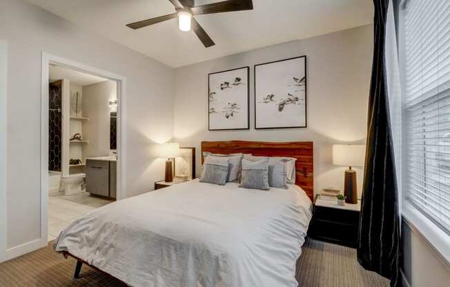 a bedroom with a bed and a ceiling fan