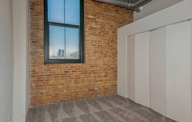 Bedroom with closet space and plush carpeting at Carriage House Lofts, Chicago, IL