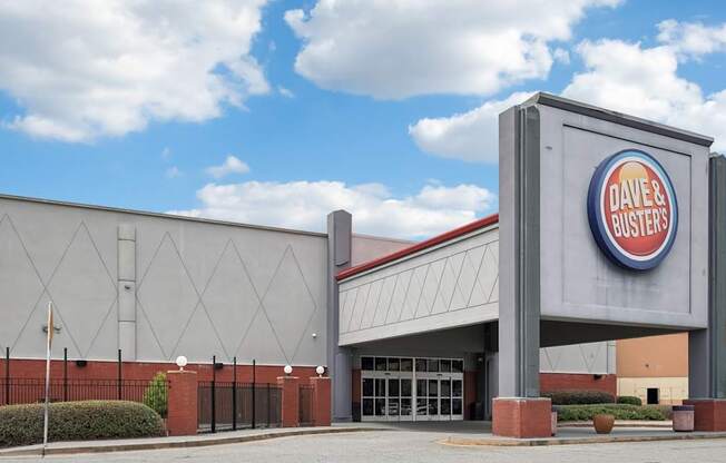 Dave and Buster's storefront with a blue sky and clouds in the background.
