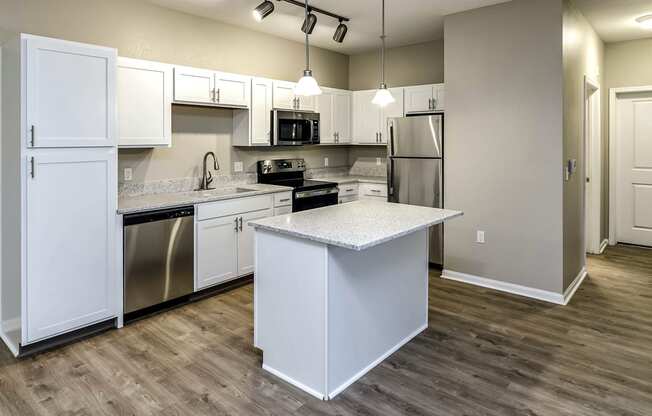 Large kitchen with white cabinets and stainless steel appliances at Legacy Commons Apartments in Omaha, NE