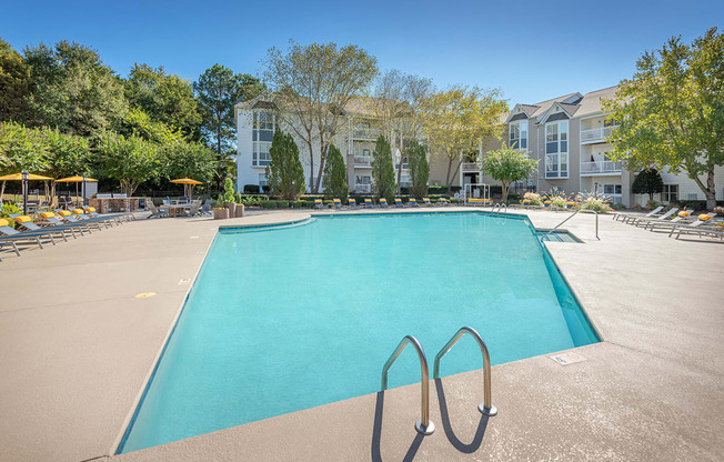 A large swimming pool with a diving board in the middle of it.