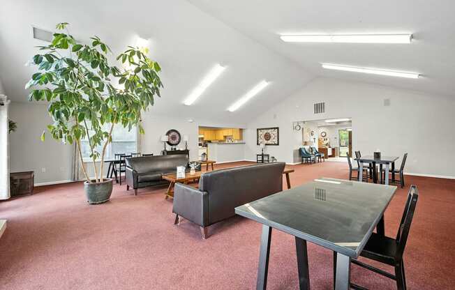 A living room with a grey couch and a table at Arbors at Georgetown Apartments, Michigan
